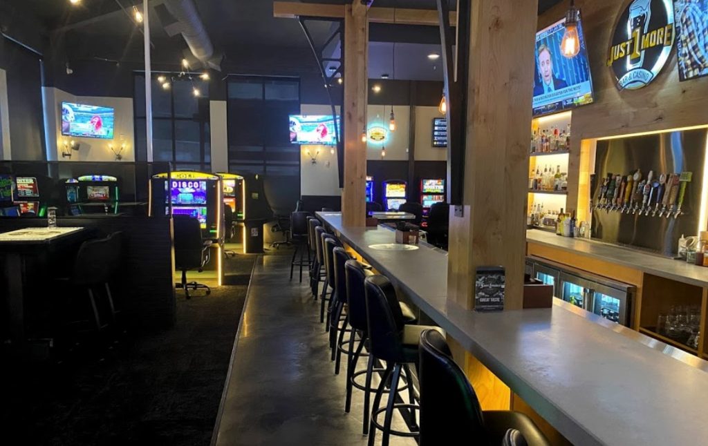 Row of gaming machines alongside the bar at Just 1 More in Billings