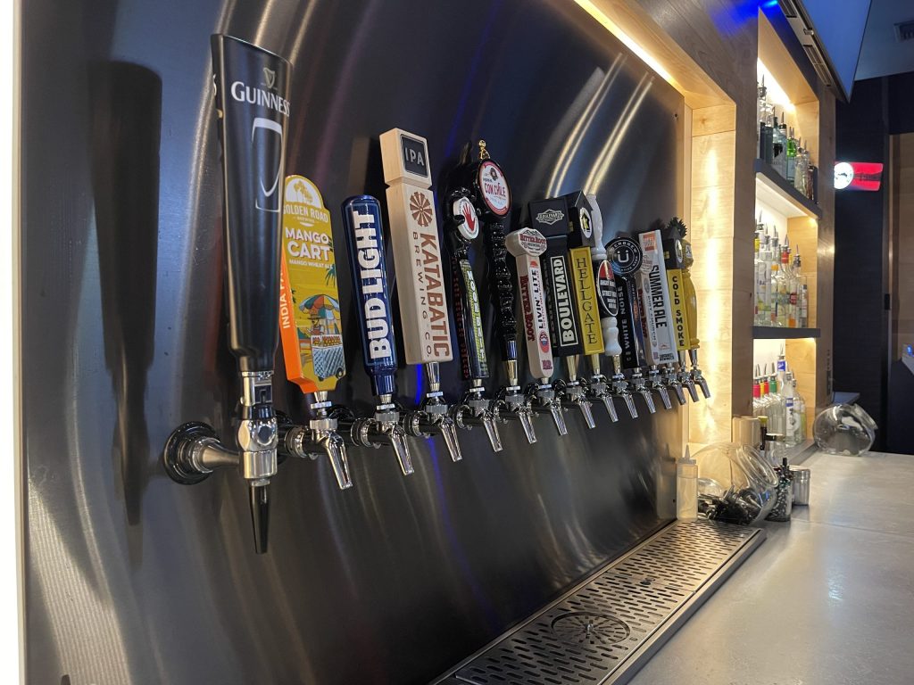 Close up of the draft beer tap handles at Just 1 More