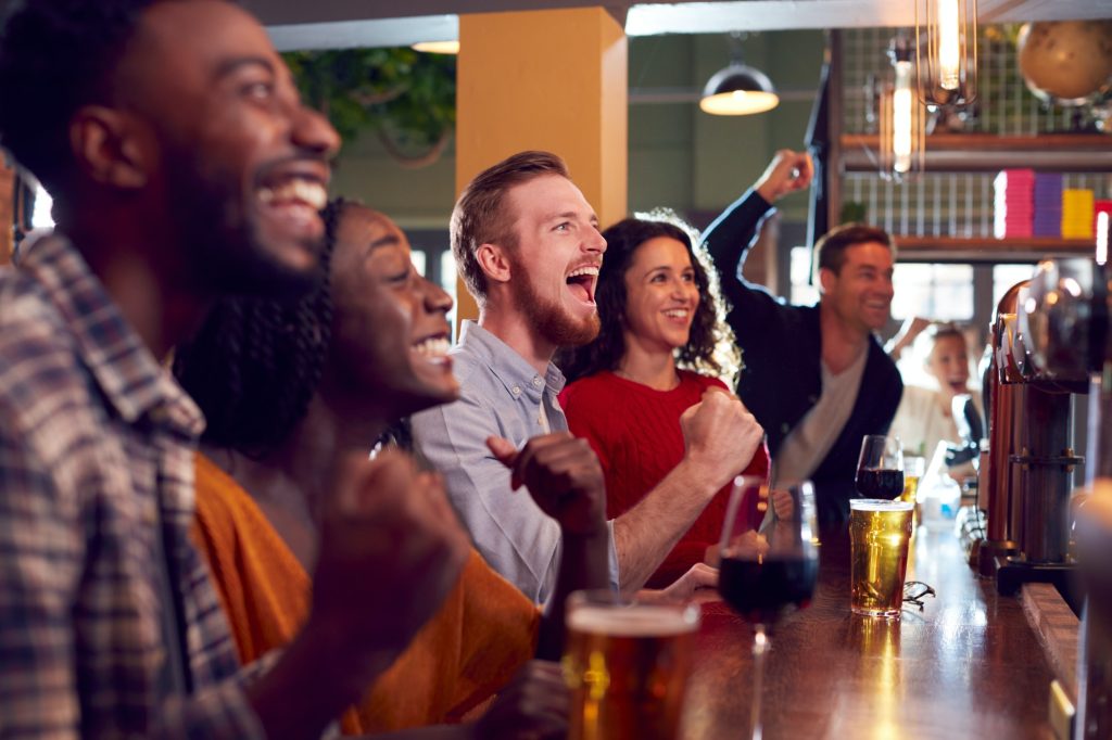 Group of friends watching a game together at a sports bar